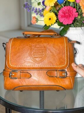 Brown Leather Messenger Bag with Top Handle and Buckle Detail